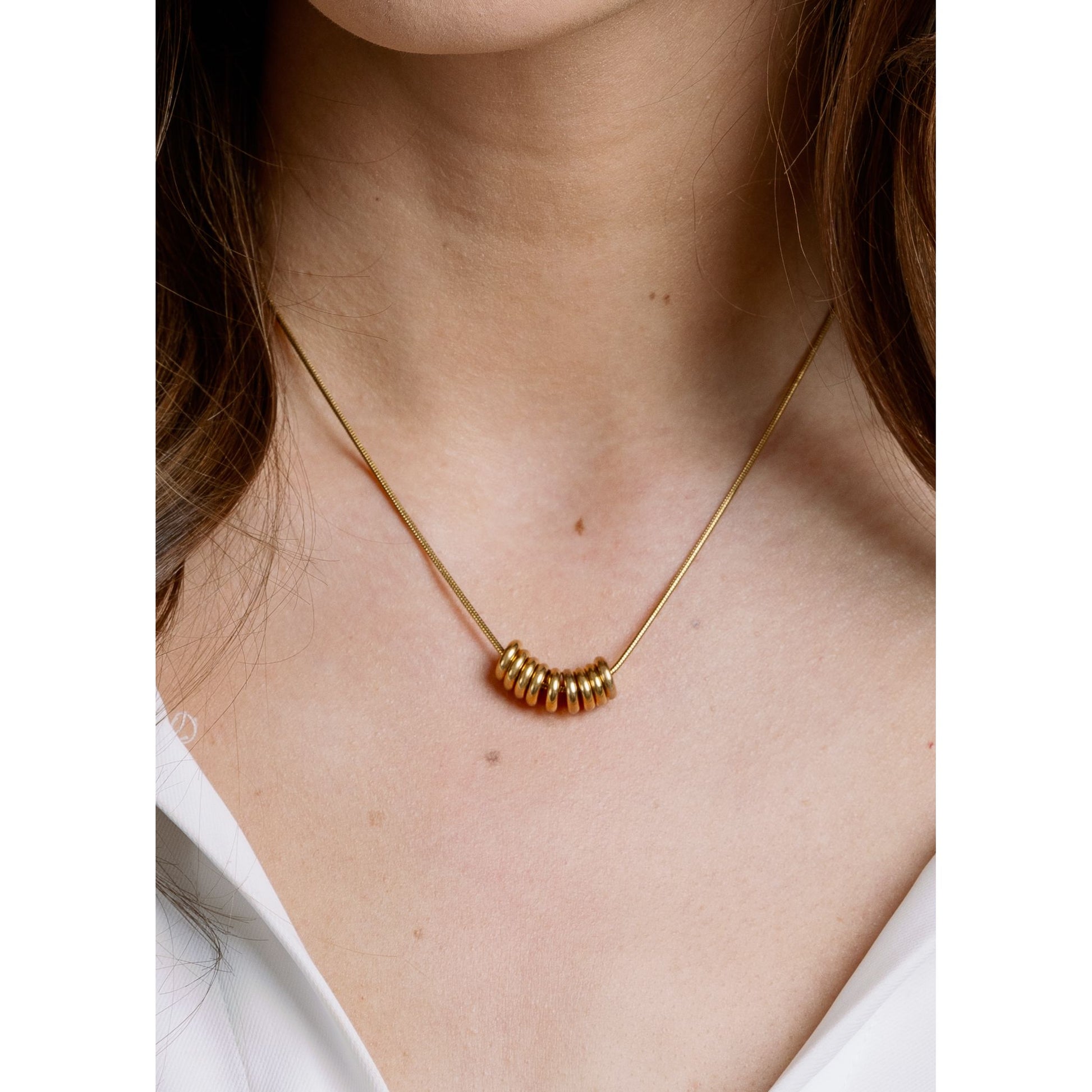Gia Necklace close-up — gold looped charm detail from Thread & Clover boutique