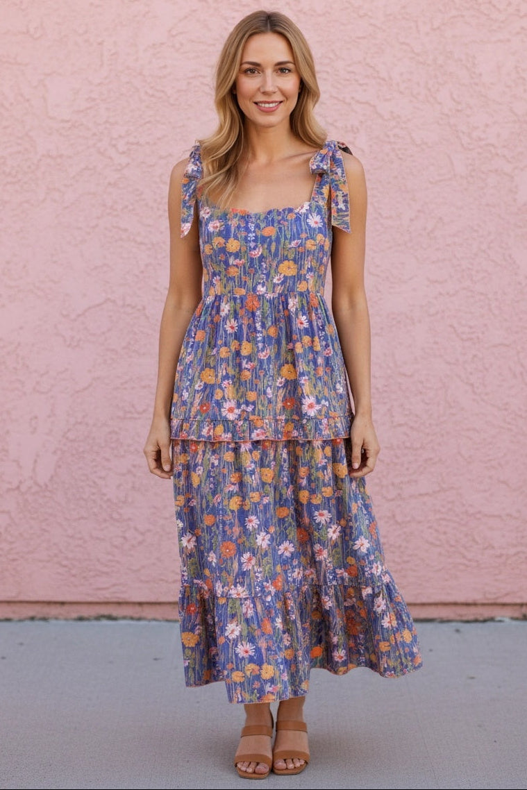Woman wearing a floral dress against a pink wall