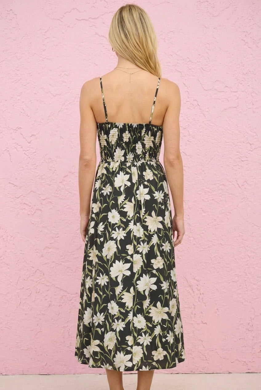 Woman wearing a floral dress against a pink textured wall