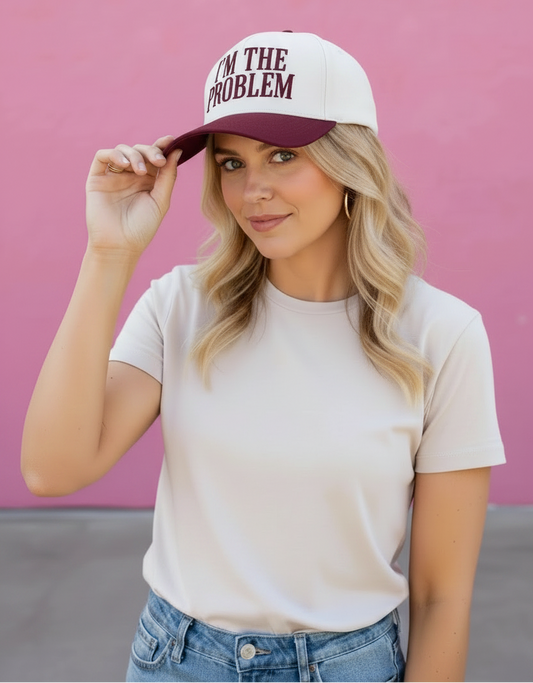 Woman wearing a cap with text against a pink background